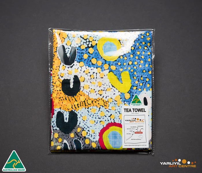 Image of tea towel with artwork by Rosie Lala in packaging.