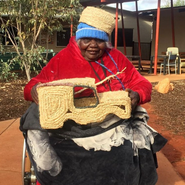 Image of artist Nellie Patterson with a woven troopy