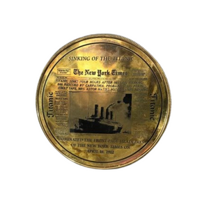 Back of compass casing with etched news article of the sinking of the titanic