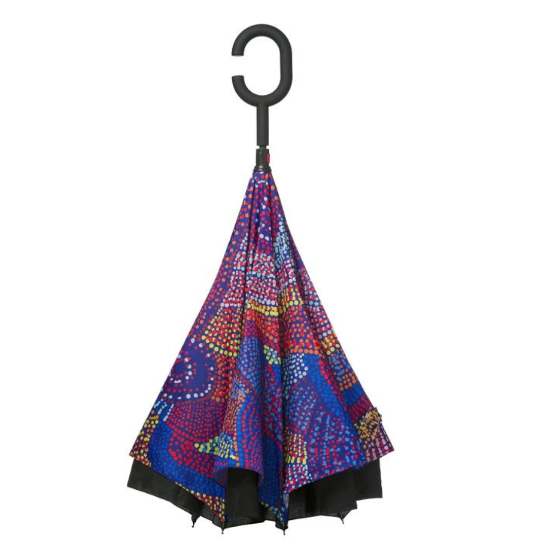 Image of the Invert Umbrella with artwork by Megan Kantamarra showing folded umbrella