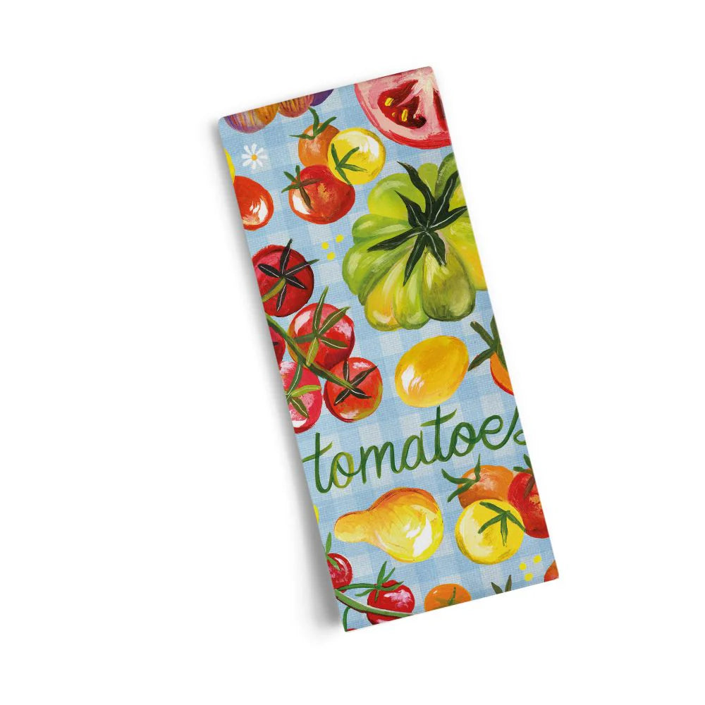 Folded kitchen towel with painted tomatoes and the word "tomatoes" on a light blue background.